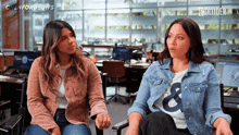 two women are sitting next to each other in an office with the words " glenford gifs " on the bottom right
