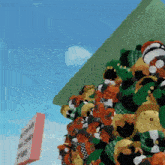 a bunch of stuffed animals are stacked on top of each other in front of a sign that says ' disney '