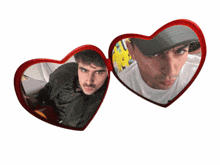 a man in a hat is reflected in a pair of heart shaped mirrors