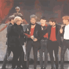 a group of people hugging each other on a stage