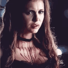 a close up of a woman with blood on her chest .