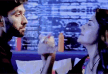 a man and a woman are looking at each other in a blurry photo