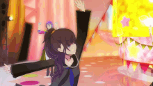 a girl in a black dress is dancing on a stage with her arms in the air .