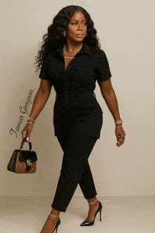 a woman in a black jumpsuit is holding a purse and has the name tomas grayson on the bottom right