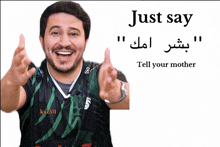a man wearing a shirt that says kaz511 is smiling and giving a thumbs up