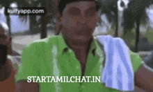 a man in a green shirt is holding a towel over his shoulder and the website starttamilchat.in is visible in the background
