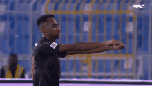a soccer player in a black jersey with the word ssc on the bottom