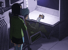 a man is sitting in a chair while a woman stands behind him