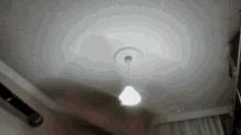 a light bulb hangs from the ceiling in a dark room