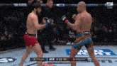 two men are fighting in a cage with the ufc logo on the bottom