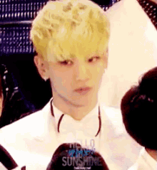 a man in a white suit and bow tie says hello sunshine