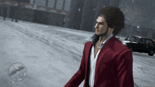 a man in a red suit stands in the snow