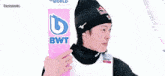 a man holding a pink sign that says bwt