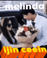 a man is giving a woman a bouquet of flowers with the name melinda written on the bottom