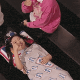 a woman is wrapped in a blanket that says 9ih on it