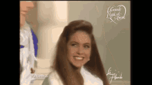 a woman is smiling in front of a sign that says cuando lluvia amor