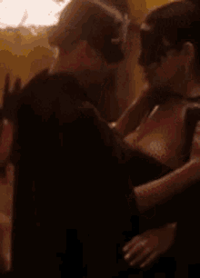 a blurry picture of a man and woman kissing