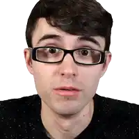 a man wearing glasses looks at the camera with a surprised look on his face