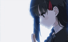 a girl with black hair and a red ribbon in her hair looks down