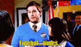 a man in a blue sweater and tie says futebol times