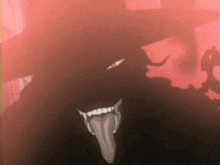 a close up of a demon 's face with its tongue sticking out in the dark .