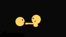 two yellow smiley faces on a black background one of which has a long tongue sticking out