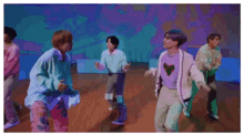 a group of men are dancing in a room with a purple background