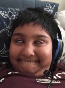 a young boy wearing headphones and a shirt that says the boston flyer