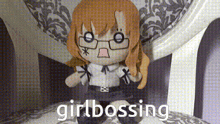a stuffed doll with glasses is sitting on a chair with the words girlbossing written below it