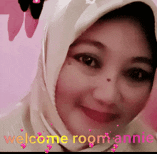 a woman wearing a hijab is smiling with the words welcome room annie above her