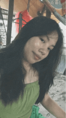 a girl in a green top is taking a picture