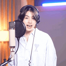 a person wearing headphones and a shirt with a heart on it