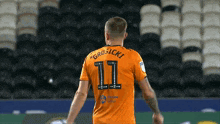 a soccer player with the number 11 on the back of his shirt