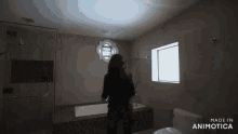 a woman in a bathroom with the words made in animotica on the bottom right