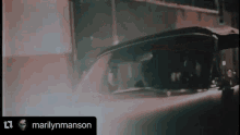a video of a man driving a car with the name marilyn manson on the bottom