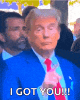 a man in a blue suit and red tie says i got you !!