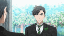 a man in a tuxedo is looking at another man