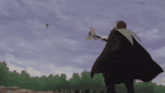 a man in a cape is holding a sword and looking at a bird flying in the sky