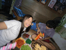 a woman eating a bag of lays chips while a man looks on