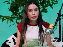 a woman is sitting in front of a microphone with a yellow rubber duck on it