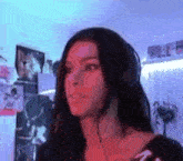a woman wearing headphones is standing in a room .