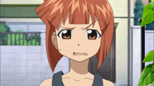 a girl with red hair and a black tank top looks angry