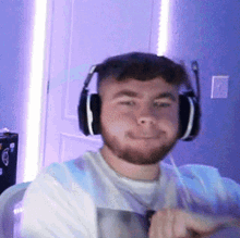 a man with a beard wearing headphones with a microphone
