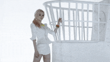 a woman in white shorts and a yellow collar is standing in front of a white cage