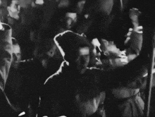 a black and white photo of a group of people dancing