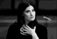 a black and white photo of a woman with her hand on her chest and the word sapphic on the bottom .