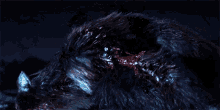 a close up of a monster in the dark with blood coming out of it 's mouth