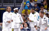 a group of basketball players with one wearing a jersey that says gay on it