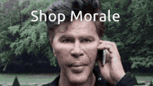 a man is talking on a cell phone with the words `` shop morale '' above him .
