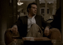 a man sitting in a chair with the words a meeting of minds
